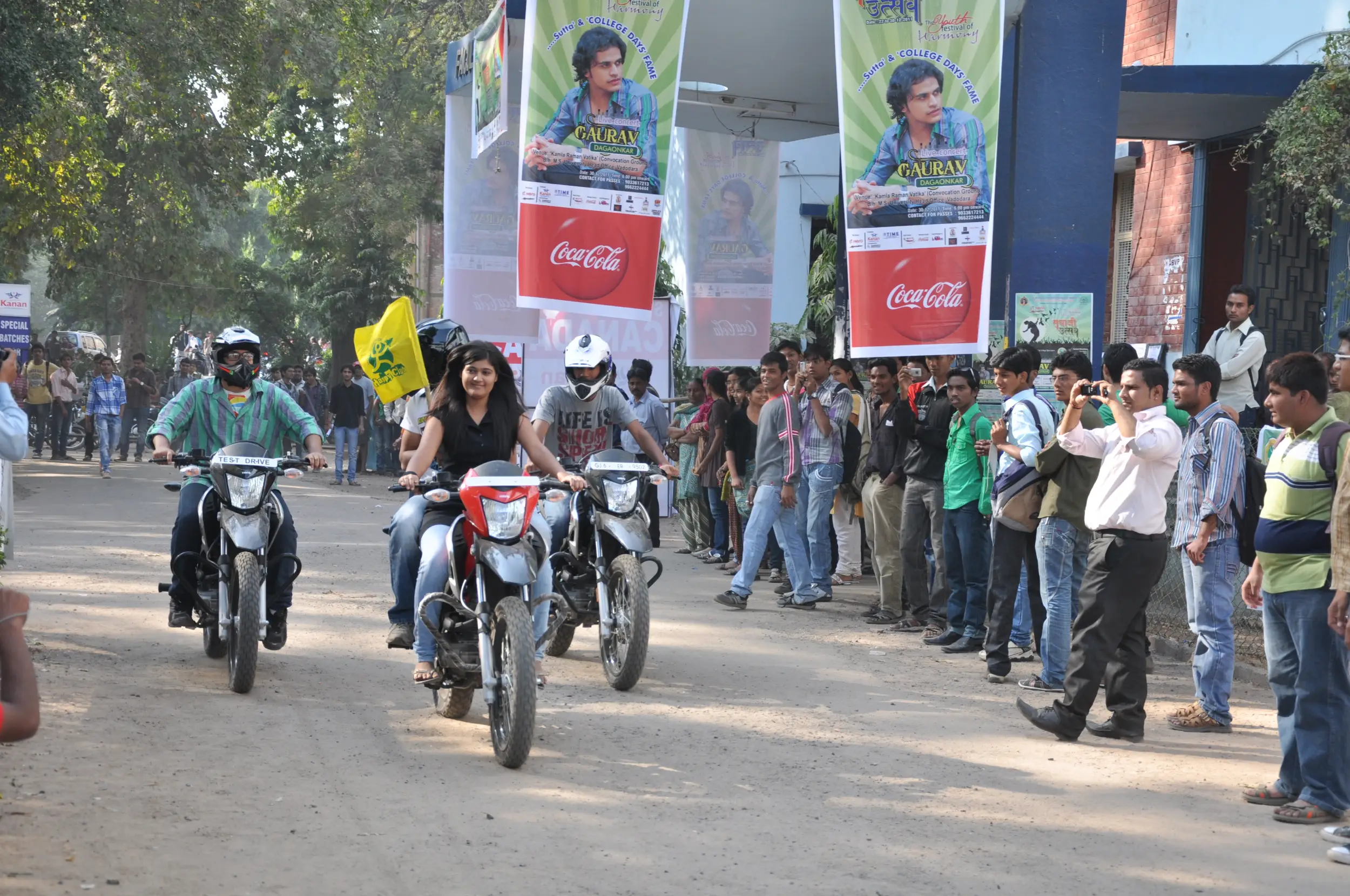 Group of men posing with large cartoon character inflatable figures at night outdoors